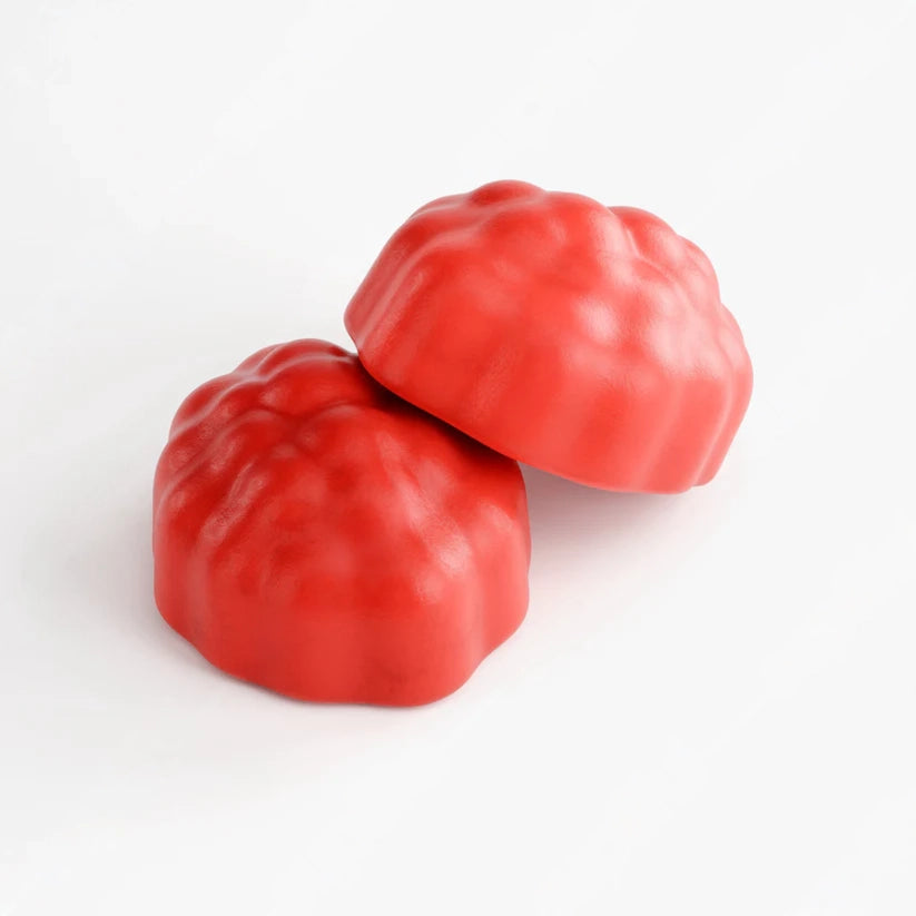 Two red gummy candies on a white background